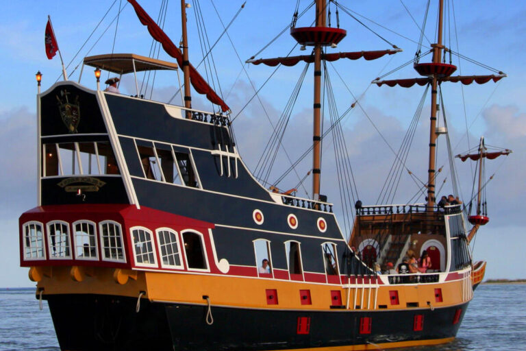 black pirate ship named Raven sails on the ocean
