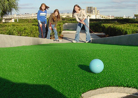 A fun miniature golf scene with creative holes and bright colors
