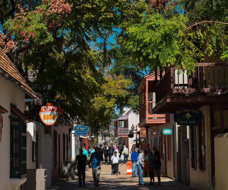 St. George Street filled with visitors, showcasing colorful storefronts